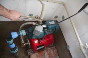 home 15 expert plumber repairing sump pump system in basement in Kenosha WI
