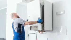 home 16 plumber fixing water heater system in Kenosha Wisconsin