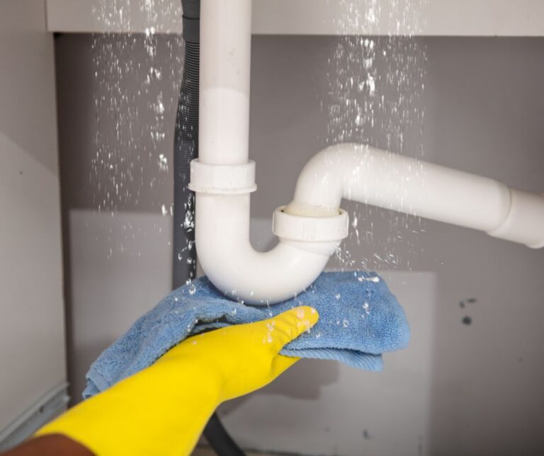 home 24 Professional plumber repairing residential plumbing system inside an older Kenosha home with modern plumbing tools
